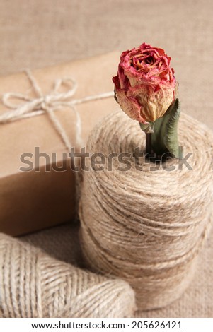 Natural style handcrafted gift box on sackcloth background. Concept of natural style design