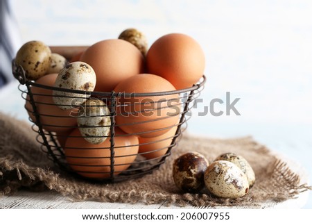 Many eggs in basket on wooden background