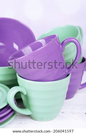 Bright dishes on table on bright background