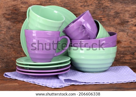 Bright dishes on napkin on wooden background