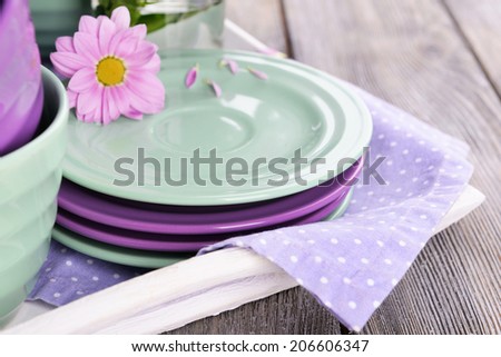 Bright dishes with flowers on table close up