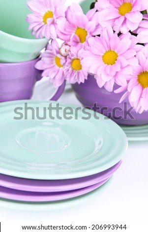 Bright dishes with flowers close up