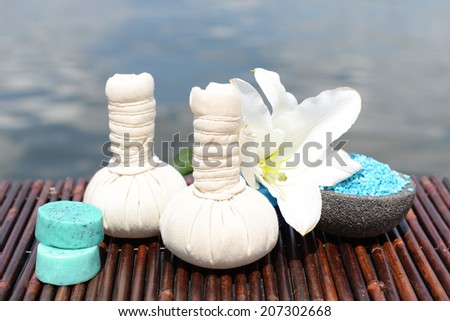 Herbal remedies for massage on bamboo mat, outdoor