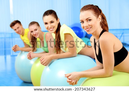 Group of young people training with gymnastic ball