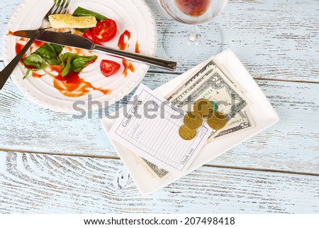 Check and remnants of food on table in restaurant