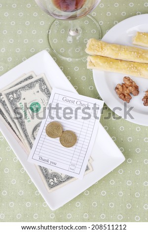 Check and remnants of food and drink on table in restaurant