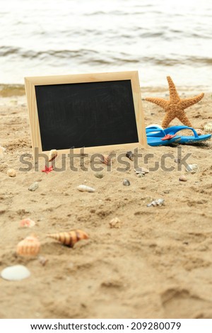 Blank chalkboard on beach background