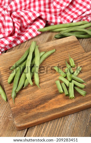 French beans on cutting board on table close-up