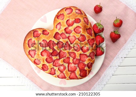 Tasty strawberry pie on table