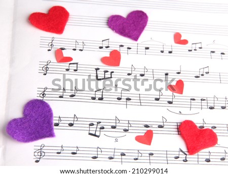 Decorative hearts on music book, close-up