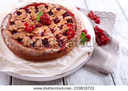 Tasty cake with berries on table close-up