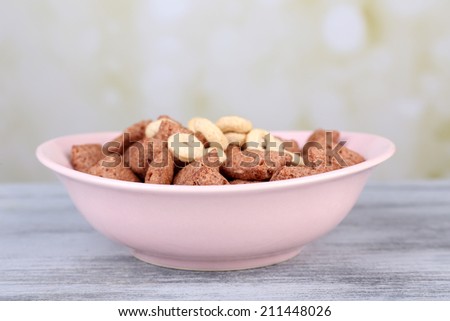 Dry breakfast in pink plate on wooden background