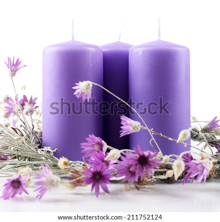 Candles with dried flowers isolated on white
