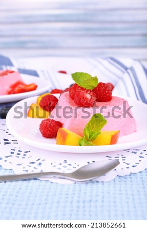 Cakes with fruit and berries on plate on lace napkin