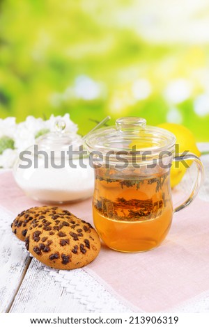 Cup of tea on table on bright background