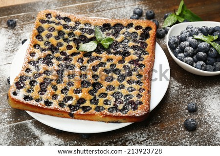 Tasty blueberry pie on table