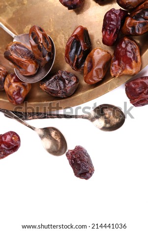 Tasty dates fruits on old metal tray, isolated on white