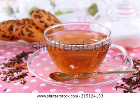 Cup of tea on table on brick wall background