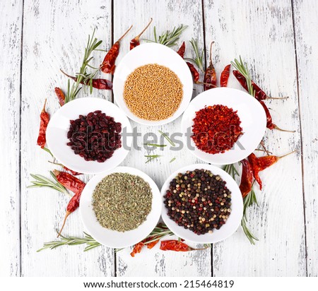 Spice with herbs and dried chilly pepper on wooden background