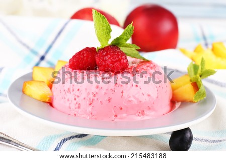 Heart shaped cake with fruits and berries on plate on tablecloth