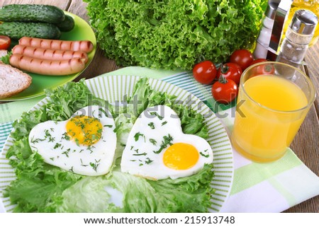 Scrambled eggs with sausage and vegetables served on plate on napkin