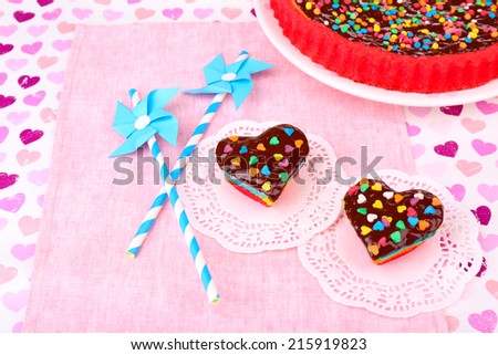 Delicious rainbow cakes on paper napkin, on bright background