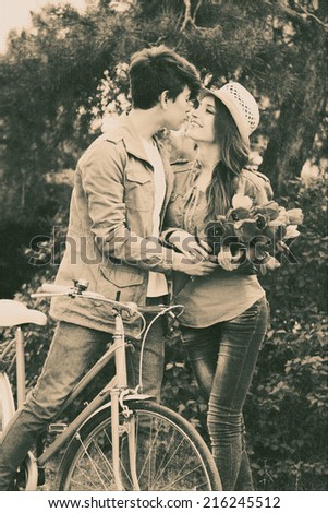 Young couple with bicycle in park