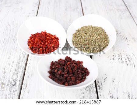 Spice in round bowls on wooden background