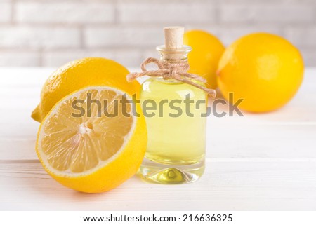 Lemon oil on table on light background