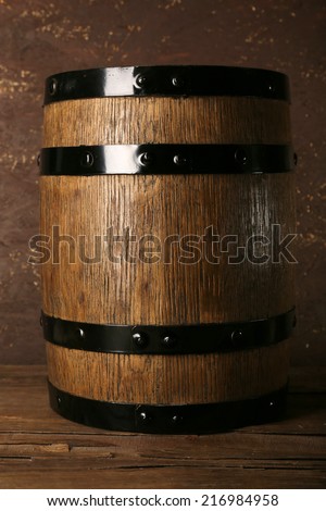 Barrel on wooden table on wooden wall background