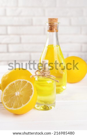 Lemon oil on table on light background