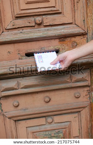 Letter in hand near postbox