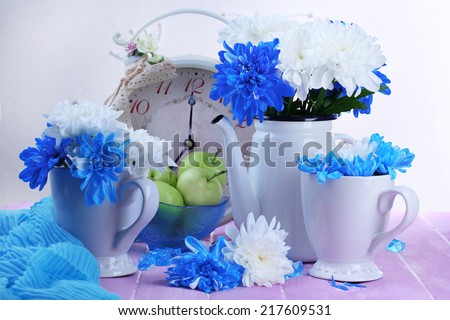 Composition of white and blue chrysanthemum and utensil close-up