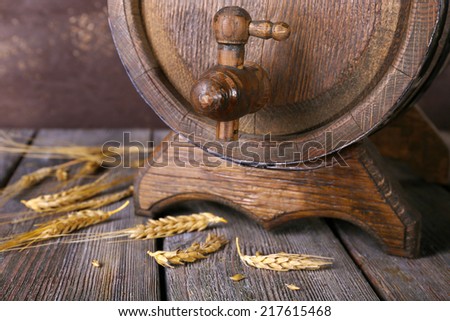 Barrel and ears on wooden table on wooden wall background