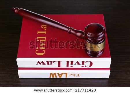 Books of Law and hammer on table close-up