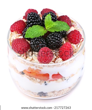 Healthy breakfast - yogurt with  fresh fruit, berries and muesli served in glass jar, isolated on white