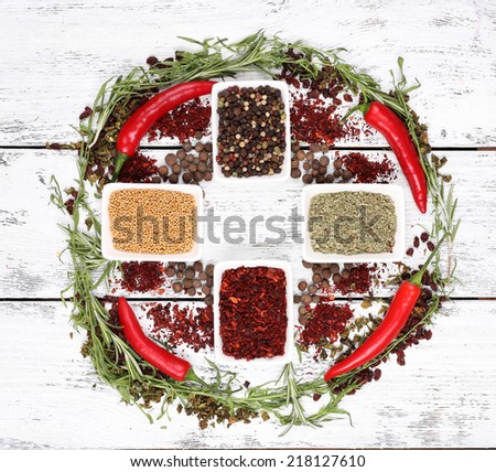Spice with herbs and dried chilly pepper on wooden background