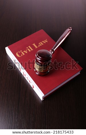 Civil Law book with hammer on wooden table