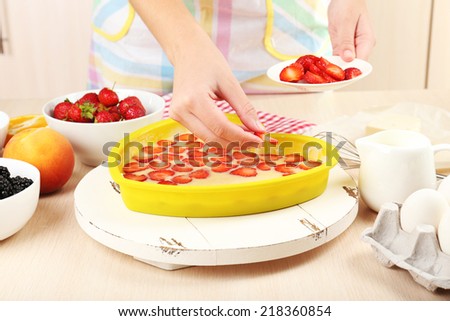 Baking tasty pie and ingredients for it on table in kitchen