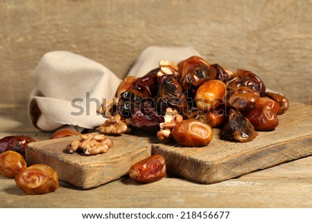 Tasty dates fruits on wooden table