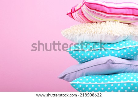 Bright pillows on pink background