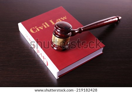 Civil Law book with hammer on wooden table
