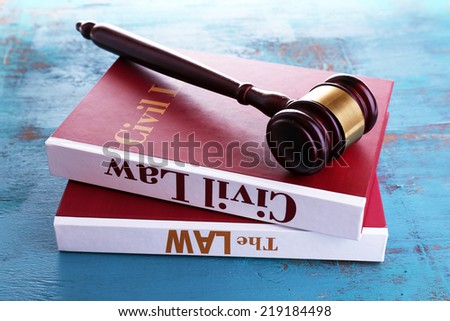 Books of Law and hammer on table close-up