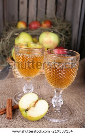 Still life with tasty apple cider in barrel and fresh apples