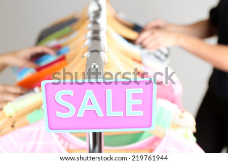 Fashion clothes on shelves in store. Shopping concept