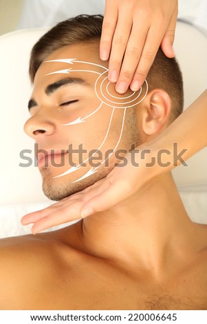 Face massage. Man having head massage (with arrows)