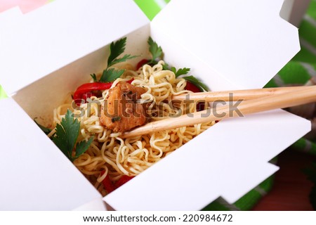 Chinese noodles in takeaway box closeup