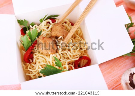 Chinese noodles in takeaway box closeup