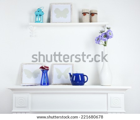 Different objects on white shelf in living room