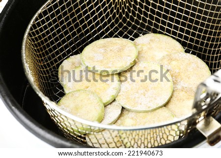 Zucchini in deep fryer, closeup